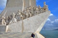 LISBON, PORTUGAL - NOVEMBER 3, 2017: A tourist couple watching the Monument of the Discoveries Padrao dos Descobrimentos located