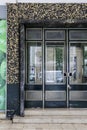 Aluminum door with geometric on tiled facade