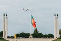 Flag of Portugal at Eduardo VII Park juxtapositioned against an aircraft belonging to TAP