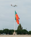 Flag of Portugal at Eduardo VII Park juxtapositioned against an aircraft belonging to TAP