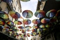 Multicolored umbrellas hanging on the Pink street in Lisbon