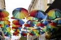 Multicolored umbrellas hanging on the Pink street in Lisbon