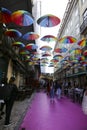 Multicolored umbrellas hanging on the Pink street in Lisbon