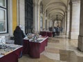 Lisbon, Portugal, October 30, 2021: People walking and shopping in market stands at Archway surrounding Praca do