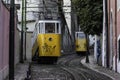 Lisbon Portugal - 30 October 2020: View of two yellow tram driving on the slope in Lisbon city center near Baixa and Chiado