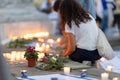 Lisbon, Portugal October 10, 2023. A woman, flowers and candles at the memorial to the fallen Israelis in October 2023