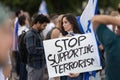 Lisbon, Portugal, October 10, 2023, A woman at a rally in support of Israel, in her hands is a poster Stop supporting