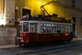 10-29-2022 LISBON, PORTUGAL: red tram with people on the tracks