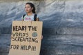 Activist holding a sign in protest for climate change