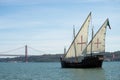 Vintage sailboat on the tagus river with the famous 25th april suspension bridge on background