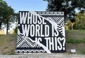 Whose world is this? - an inscription on a billboard
