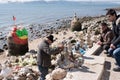 LISBON, Portugal, 23/02/2018: a street artist builds statues with the technique of balancing stone art, people look amazed and Royalty Free Stock Photo