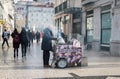 Lisbon, Portugal - Street vendor selling roasted chestnuts during wintertime with tourists walking in the background Royalty Free Stock Photo