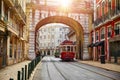 Lisbon Portugal. Vintage red retro tram on narrow bystreet Royalty Free Stock Photo