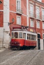 Lisbon, Portugal. Vintage red retro tram on street tramline in Alfama district of old town. Popular touristic attraction Royalty Free Stock Photo