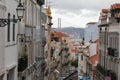 Portugal, Lisbon - a view on the narrow street and the red bridge in the Barrio Alto Royalty Free Stock Photo