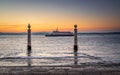 Lisbon at sunrise, boat of transport arriving with workers. & x28 Cais das Colunas& x29 Columns Wharf , perched cormorant. masoni