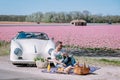 Lisse Netherlands ,. couple doing a road trip with a old vintage sport car White Porsche 356 Speedster, Dutch flower