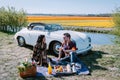 Lisse Netherlands ,. couple doing a road trip with a old vintage sport car White Porsche 356 Speedster, Dutch flower