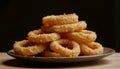 deep fried onion rings stacked high on rustic ceramic plate