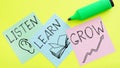 Listen, learn, grow advice or reminder are shown using the text on a sheets of paper