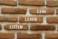 Listen learn lead symbol. Concept word Listen Learn Lead on beautiful red brown bricks. Beautiful red brown brickwall background. Royalty Free Stock Photo