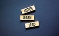 Listen learn lead symbol. Concept word Listen Learn Lead on beautiful wooden block. Beautiful black table black background. Royalty Free Stock Photo