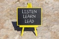 Listen learn lead symbol. Concept word Listen Learn Lead on beautiful black chalk blackboard. Red stone. Beautiful red stone Royalty Free Stock Photo