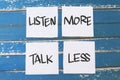 Listen more talk less, text words typography written on paper against wooden background, life and business motivational Royalty Free Stock Photo