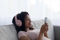 Listen to favorite music with mobile app, watch funny videos, lesson and learn English online Royalty Free Stock Photo