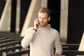 Listen to me. Man beard walks with smartphone, urban background. Man with beard serious face talk smartphone. Guy Royalty Free Stock Photo