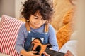 Listen to me play. a little boy playing the guitar while sitting at home. Royalty Free Stock Photo