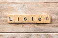 Listen word written on wood block. listen text on table, concept Royalty Free Stock Photo