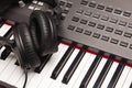 Listening Headphones Laying on Electronic Synthesizer Keyboard Royalty Free Stock Photo