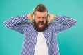 Listening heavy metal. unhappy bearded man with loud sound in earphones. Royalty Free Stock Photo
