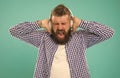 listening heavy metal. unhappy bearded man with loud sound in earphones. Royalty Free Stock Photo