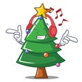 Listening music Christmas tree character cartoon Royalty Free Stock Photo