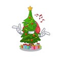 Listening music christmas tree next to cartoon table Royalty Free Stock Photo