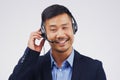 Listening, thinking and Asian man in callcenter with smile, headset and happy in studio. Male person, consultant and