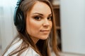 Listening to music. Young beautiful girl with big headphones on her head. Close-up. Leisure and music. Royalty Free Stock Photo