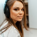 Listening to music. Young beautiful girl with big headphones on her head. Close-up. Leisure and music. Royalty Free Stock Photo