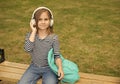 Listening to new tunes. Small kid listen to music summer outdoors. Listening comprehension. Audio learning. English Royalty Free Stock Photo