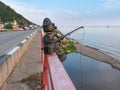 Listvyanka, Irkutsk region, Eastern Siberia / Russia - August 24, 2020: Fisherman with a fishing rod. Scrap metal sculpture