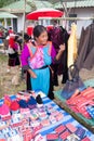 Lisu hilltribe woman in traditional dress selling bags, hats and purses at a market in Mae Hong Son, Thailand