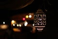 Lit Arabic lamp at night, background lights