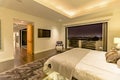 Lit bedroom of luxury California home in San Diego Royalty Free Stock Photo