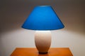 Lit bedside lamp over nightstand Royalty Free Stock Photo