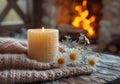 A lit beeswax candle on a rustic wooden stand, complemented by delicate yellow flowers, evokes a warm, homely atmosphere