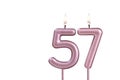 Lit birthday candle - Candle number 57 on white background