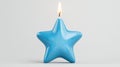 Lit Blue Star Shaped Candle on White Background Royalty Free Stock Photo